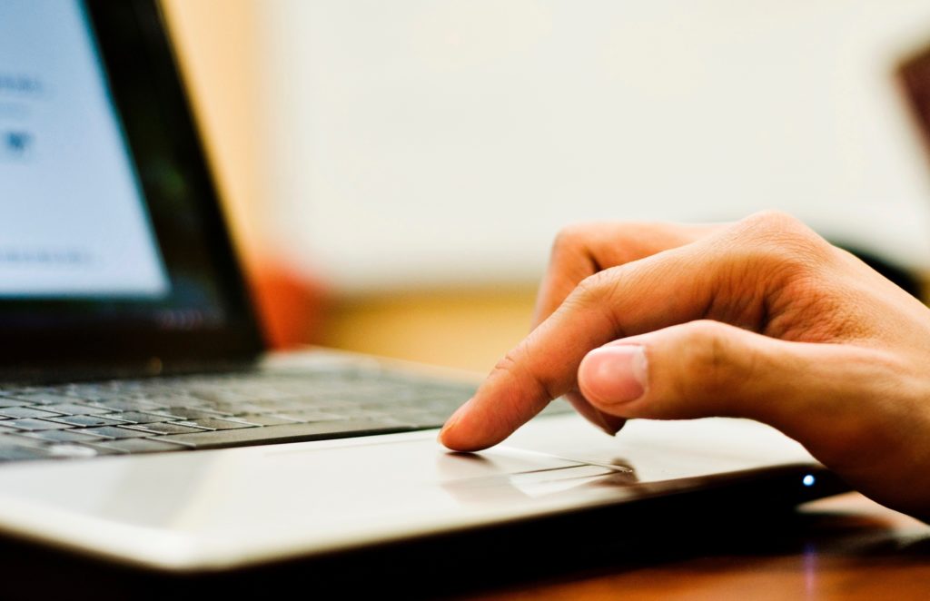 A hand on a key board.