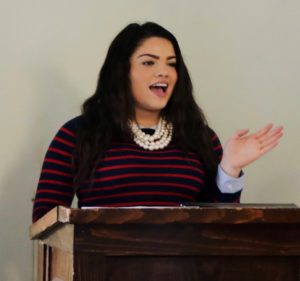 High School student presenting at a podium.
