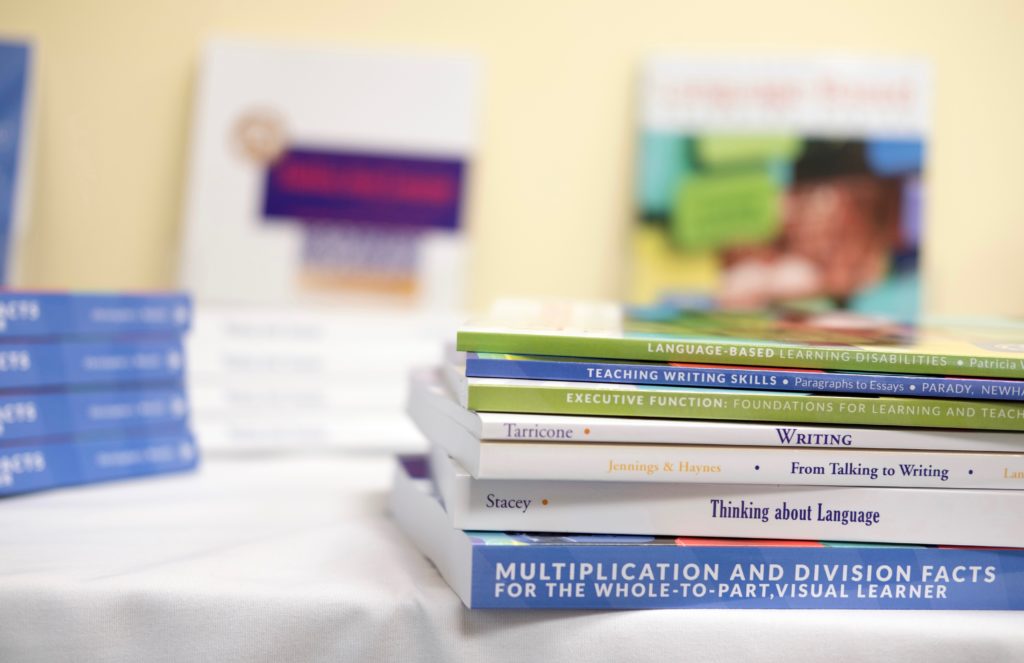 A stack of Landmark Outreach books and publications.