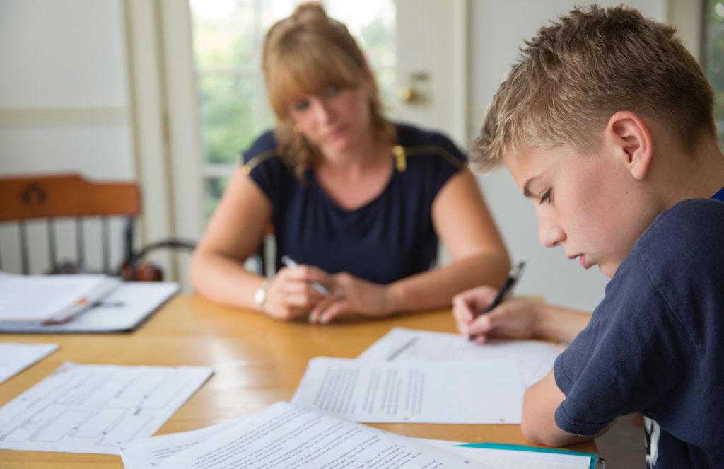 A high school student completing a writing assessment.