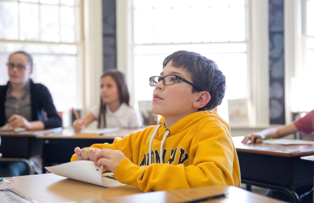 A student reading in an elementary classroom.