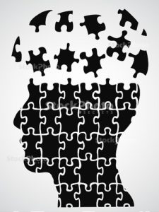 A human head depicted with linking puzzle pieces.