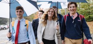 Landmark High School Student Advocates walking on campus with umbrellas.
