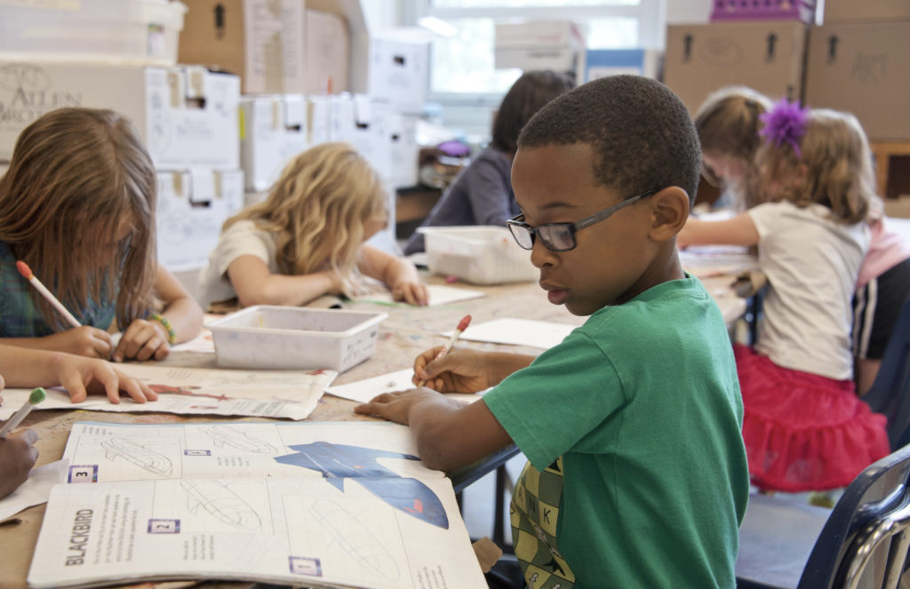 Elementary students are focused on working independently on an assignment.