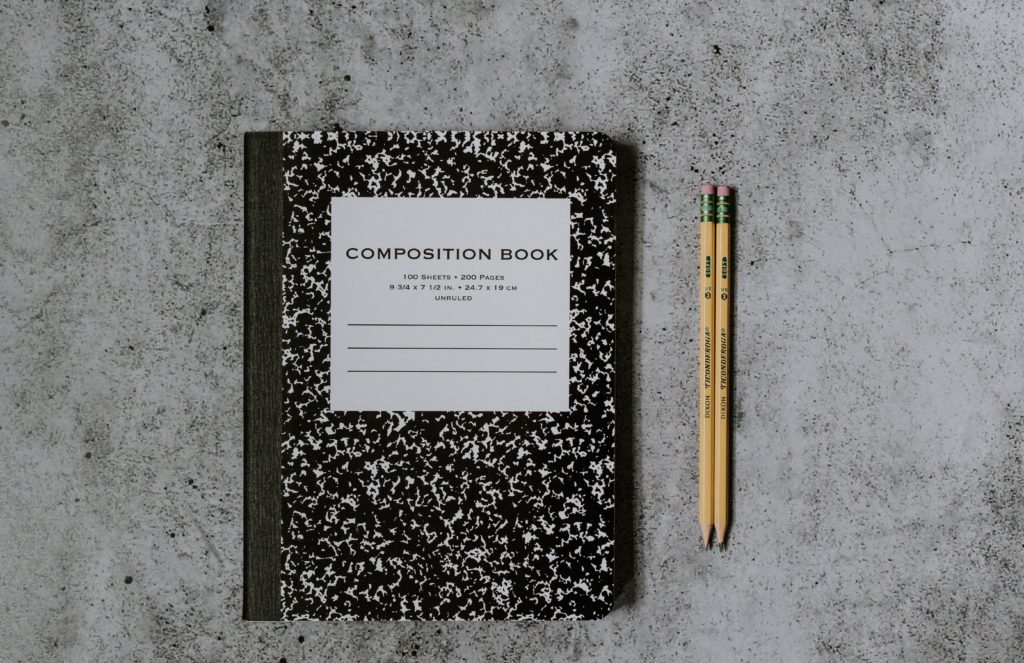 Composition notebook with a pencil.