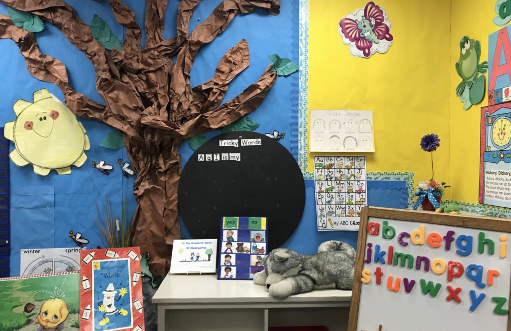 Colorful corner in an elementary classroom featuring a magnetic board with letters.