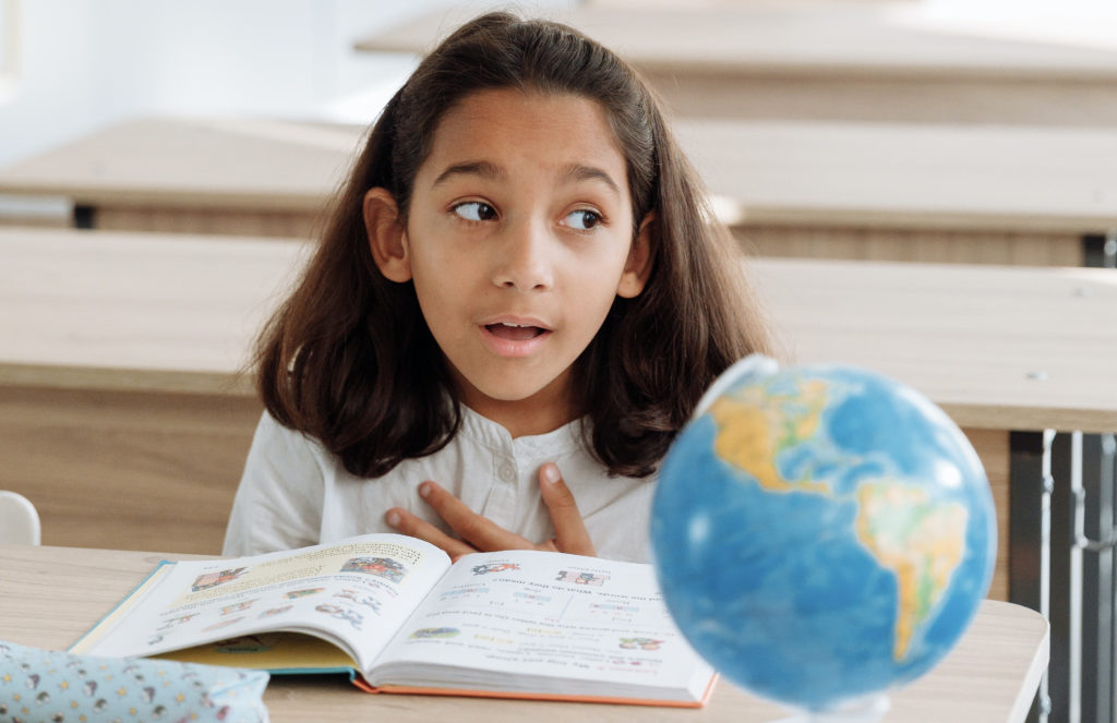 An elementary student reading an informative text.